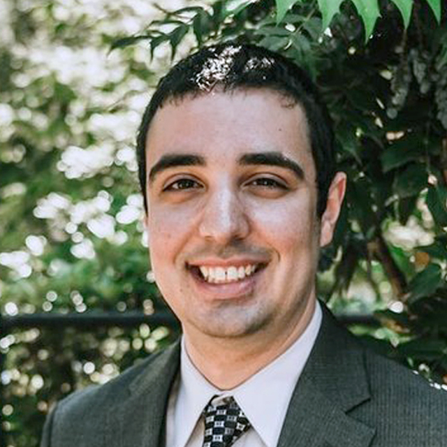 Image of Alex Mariakakis, wearing a suit